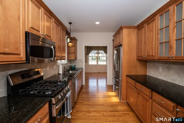 a kitchen with stainless steel appliances granite countertop a stove and a sink