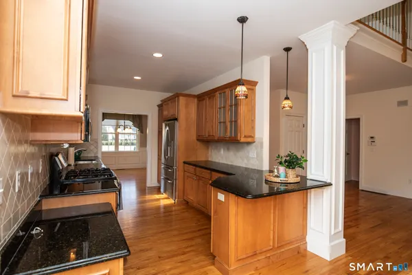 a kitchen with stainless steel appliances granite countertop a stove and a refrigerator