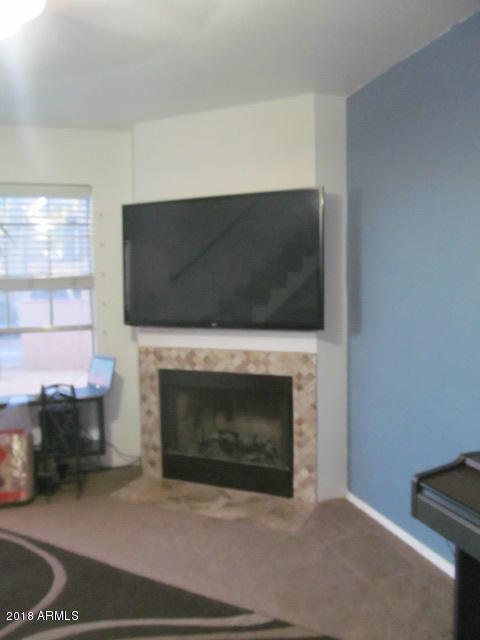 7905 West Thunderbird Road, Unit 308 Peoria, AZ 85381 - Photo 2 of 18 Fireplace and TV