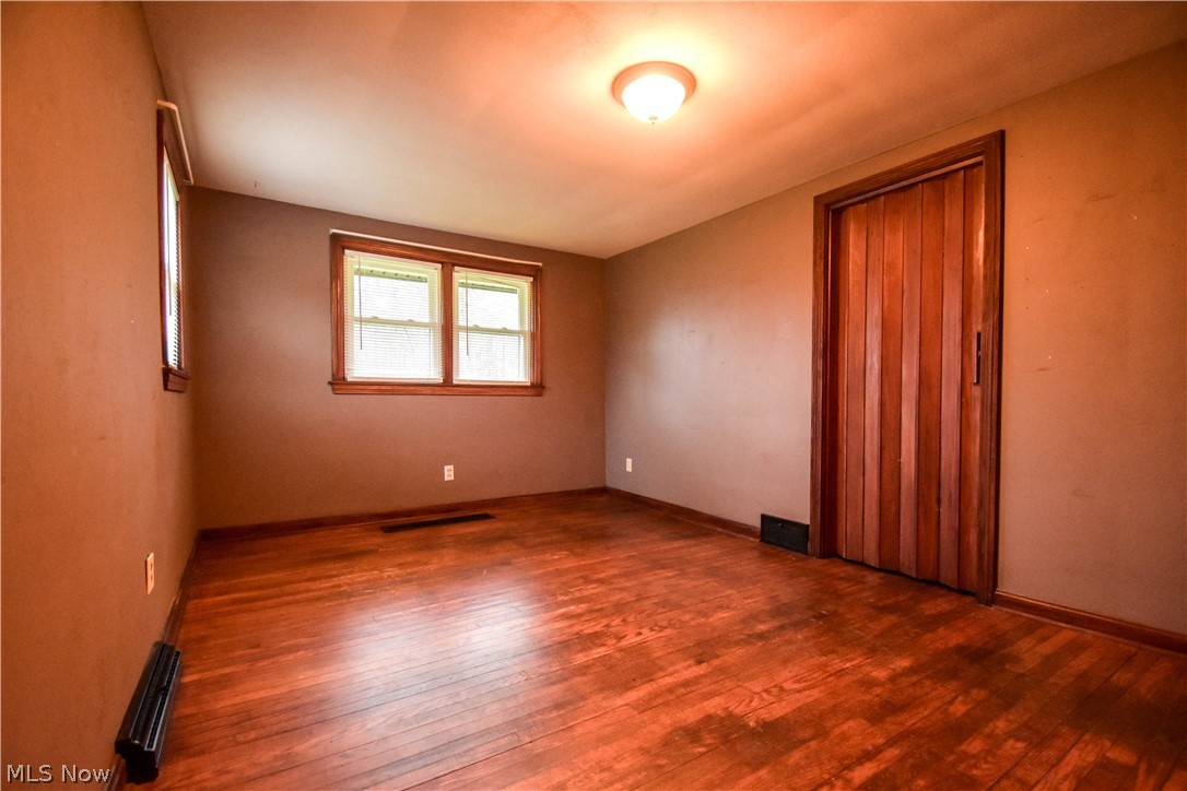 9506 Kirk Road North Jackson, OH 44451 - Photo 32 of 50 Spare room featuring hardwood / wood-style floors and a baseboard radiator