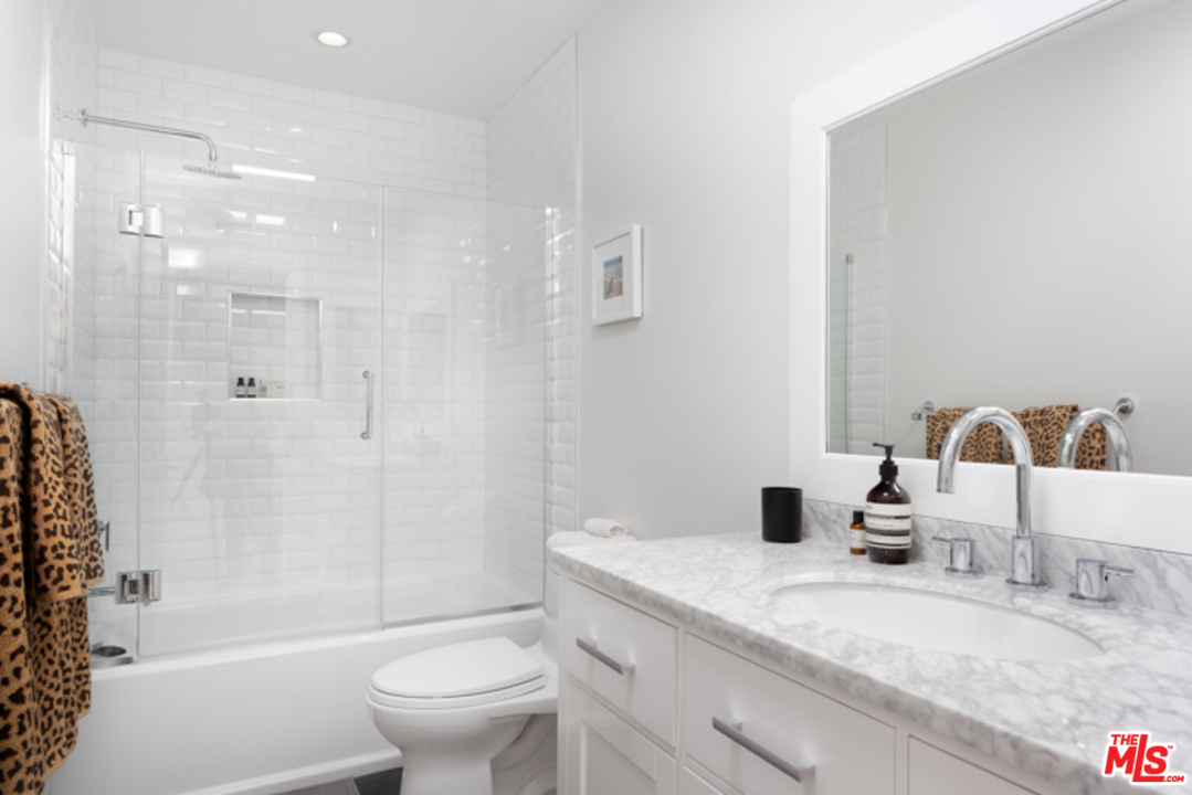 4425 Alla Road, Unit 6 Marina del Rey, CA 90292 - Photo 27 of 35 a bathroom with a granite countertop sink a toilet a mirror and shower