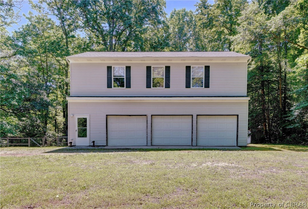 8269 Ark Road Gloucester, VA 23061 - Photo 1 of 33 View of front facade featuring a front lawn and a garage