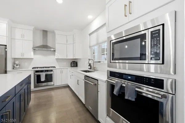 a kitchen with stainless steel appliances granite countertop a stove and a sink