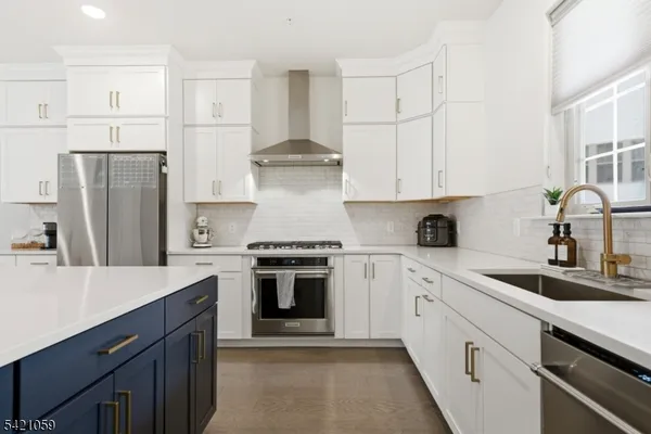 a kitchen with white cabinets and stainless steel appliances