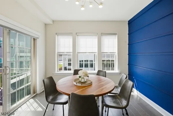 a view of a dining room with furniture a rug and wooden floor