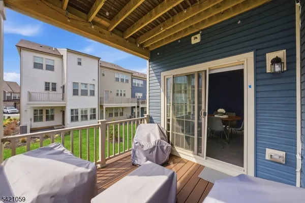 a view of a balcony with table and chairs