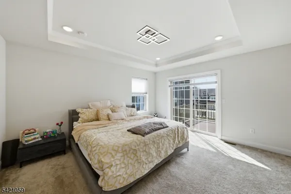 a spacious bedroom with a bed and a window