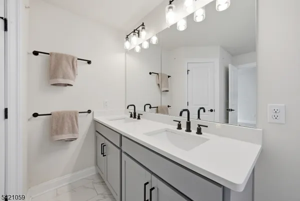 a bathroom with a sink a toilet and mirror