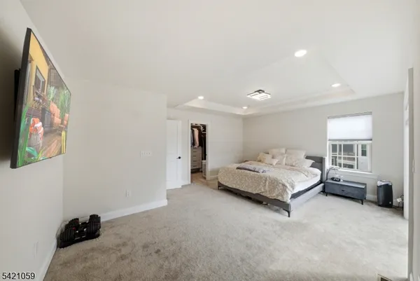 a spacious bedroom with a bed and a couch