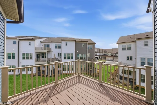 a view of a balcony with wooden floor and fence