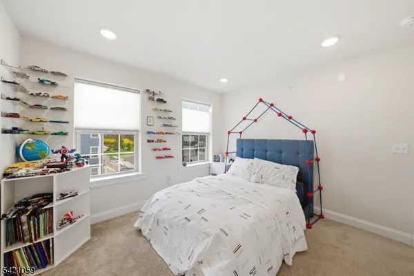 a bedroom with a bed and a book shelf