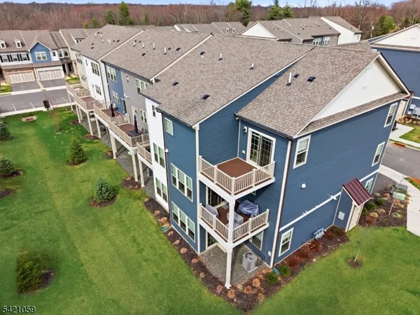 an aerial view of a house with a big yard and large trees