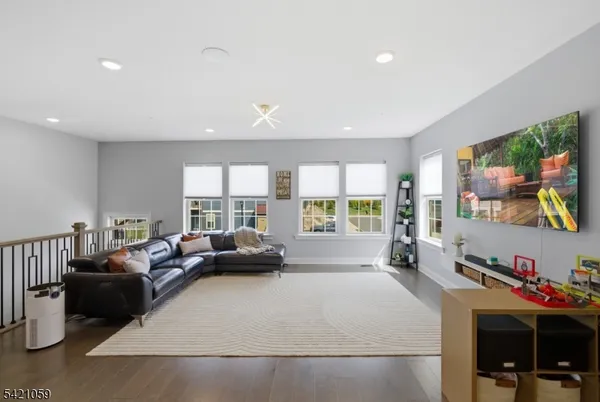 a living room with furniture large window and a flat screen tv