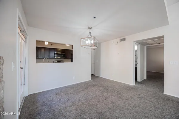 a view of a room with an empty space and a hallway