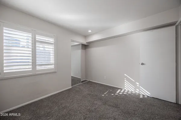 a view of an empty room and a window