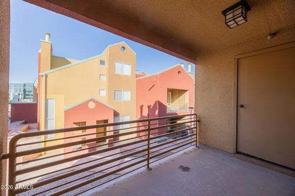 a view of a balcony with a ceiling fan