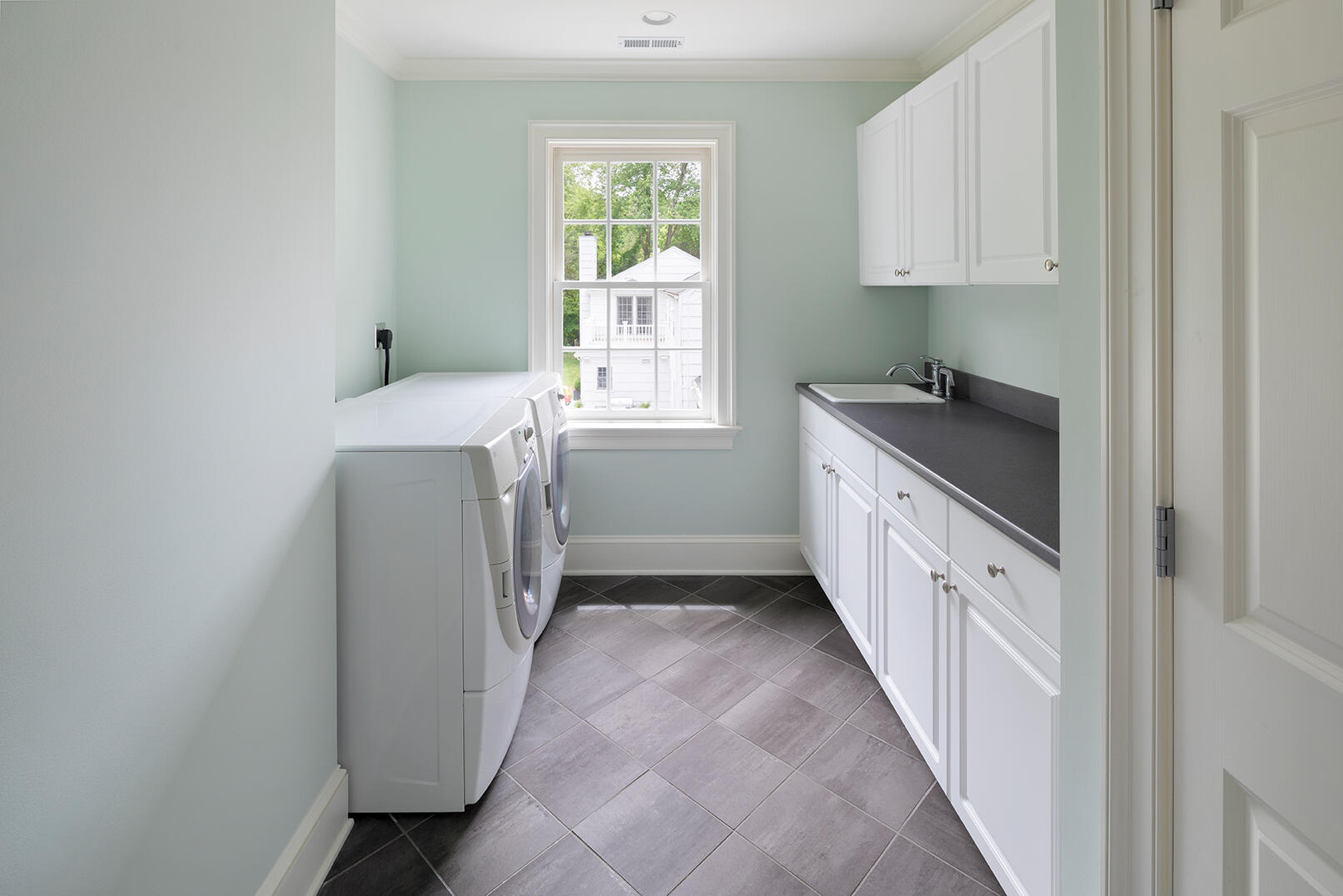 21 Briar Brae Road Darien, CT 06820 - Photo 31 of 35 a hallway with cabinets washer and dryer