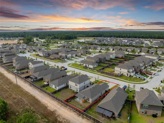 an aerial view of residential houses with outdoor space