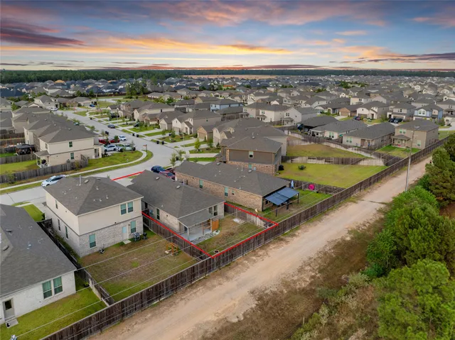 a view of a yard with a house in the background