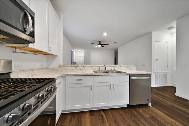 a kitchen with a sink stove and cabinets