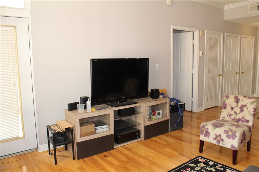 1101 Juniper Street Northeast, Unit 1416 Atlanta, GA 30309 - Photo 11 of 48 a living room with furniture and a flat screen tv