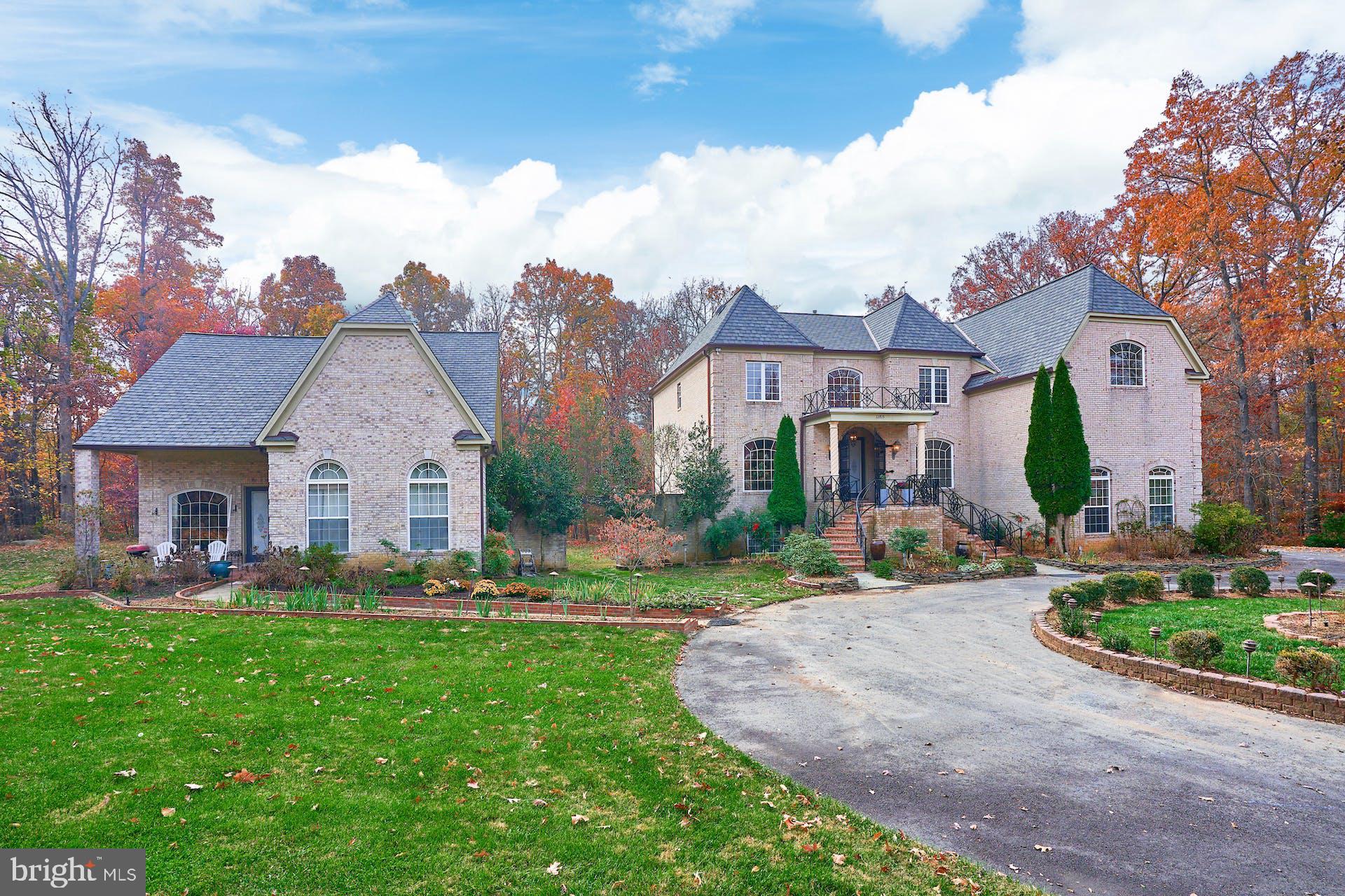 a front view of house with yard and green space