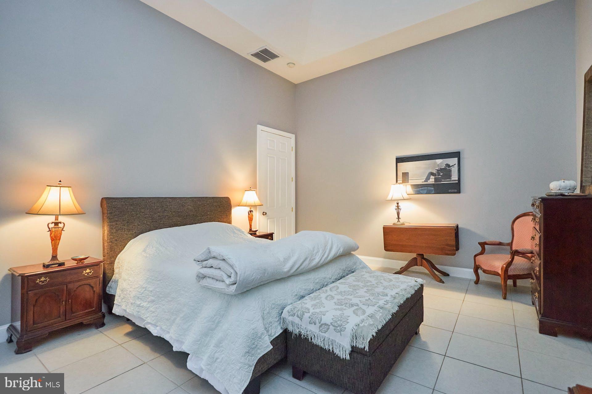 12815 Braddock Road Clifton, VA 20124 - Photo 12 of 21 a bedroom with furniture and a lamp