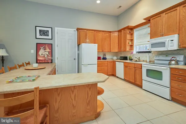 a kitchen with stainless steel appliances granite countertop a stove a sink dishwasher and a refrigerator