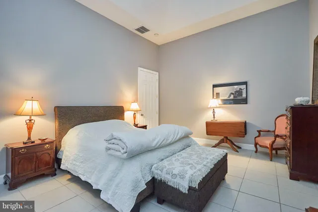 a bedroom with furniture and a lamp