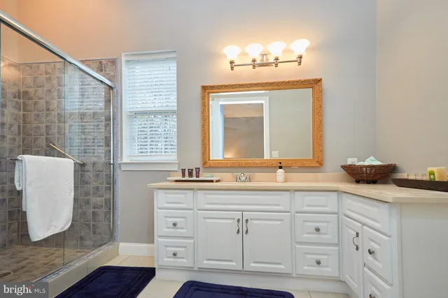 a spacious bathroom with double sink and a mirror