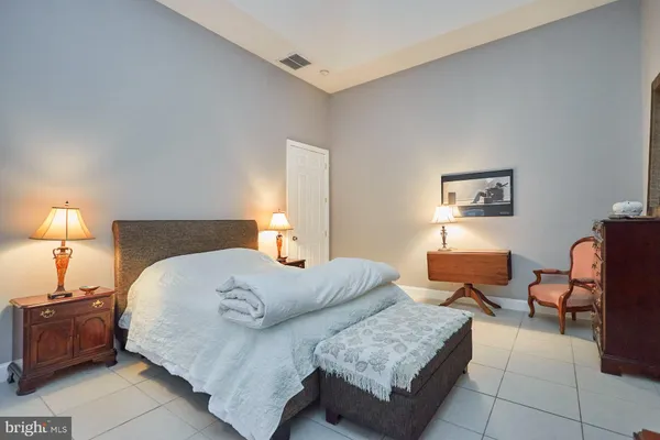 a bedroom with furniture and a lamp