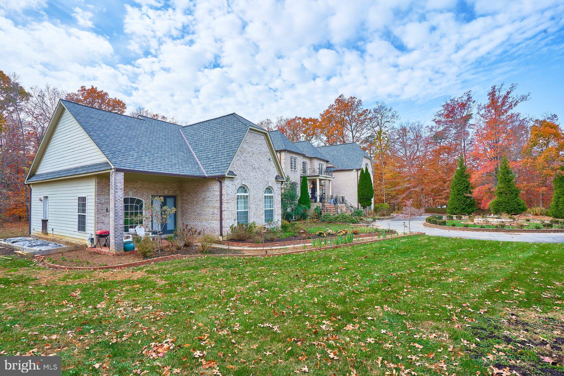 12815 Braddock Road Clifton, VA 20124 - Photo 19 of 21 a front view of a house with a yard table and chairs
