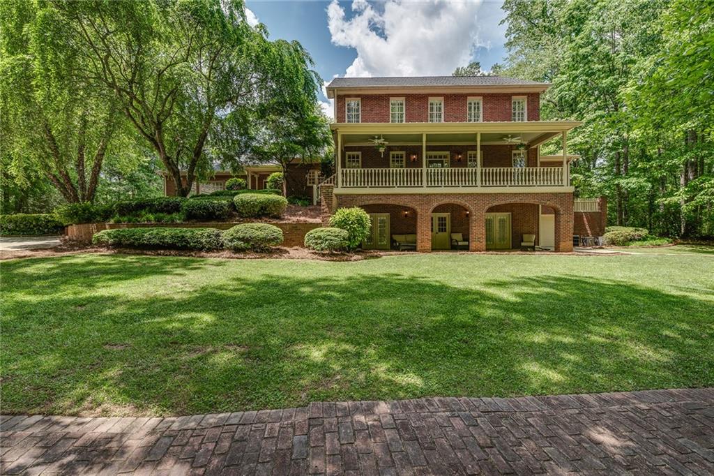 a view of a house with a yard and sitting area
