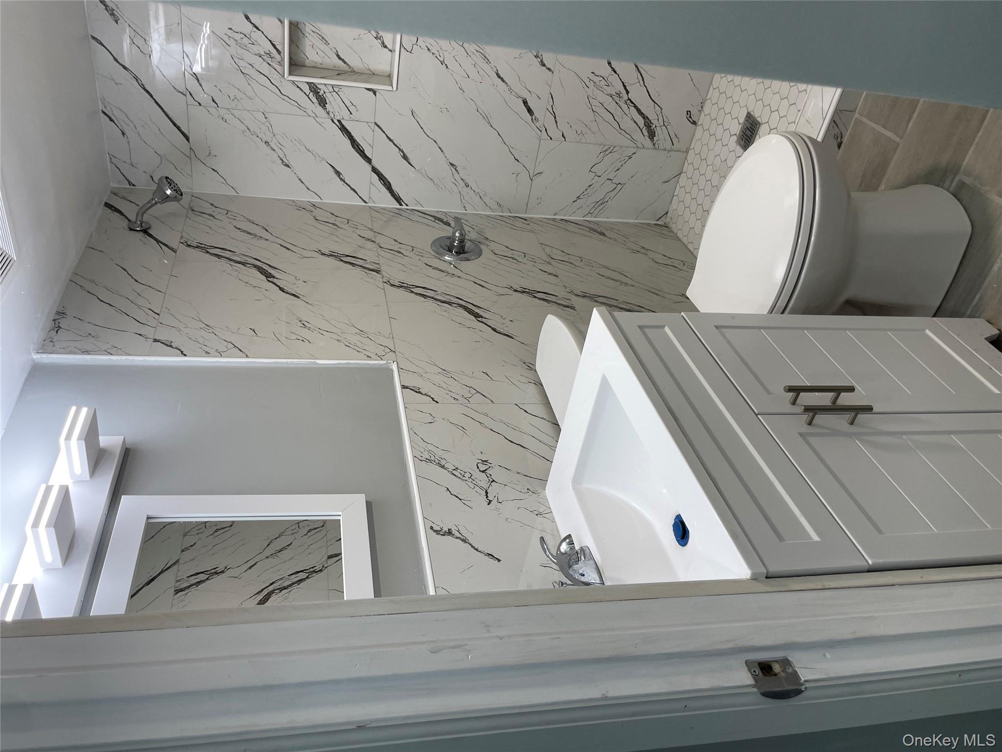 131-08 Sutter Avenue Queens, NY 11420 - Photo 15 of 21 a bathroom with a sink and toilet