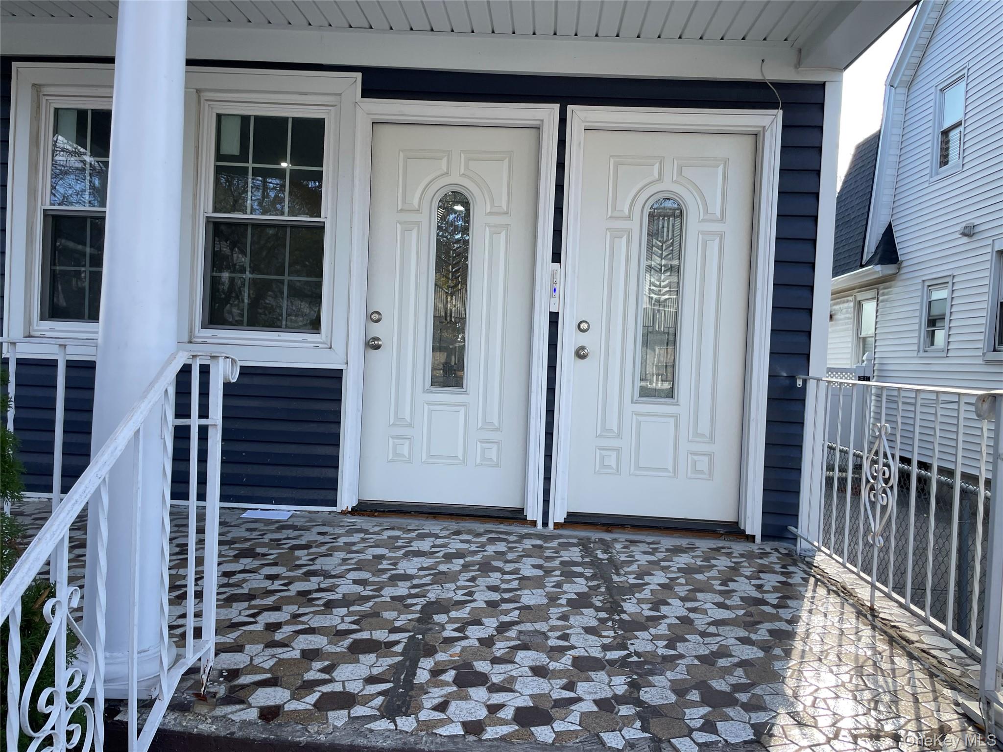 131-08 Sutter Avenue Queens, NY 11420 - Photo 3 of 21 a front view of a house with a door