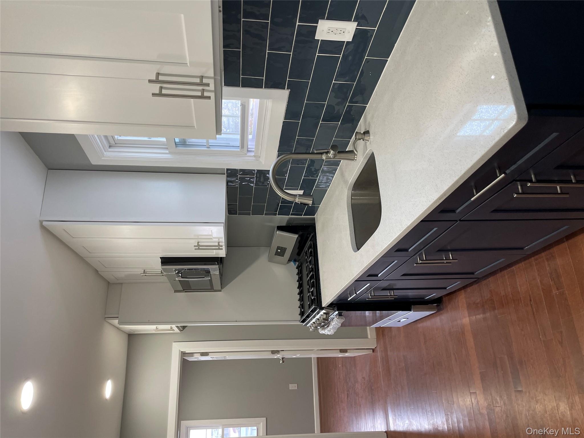 131-08 Sutter Avenue Queens, NY 11420 - Photo 7 of 21 a kitchen with a sink a stove and cabinets