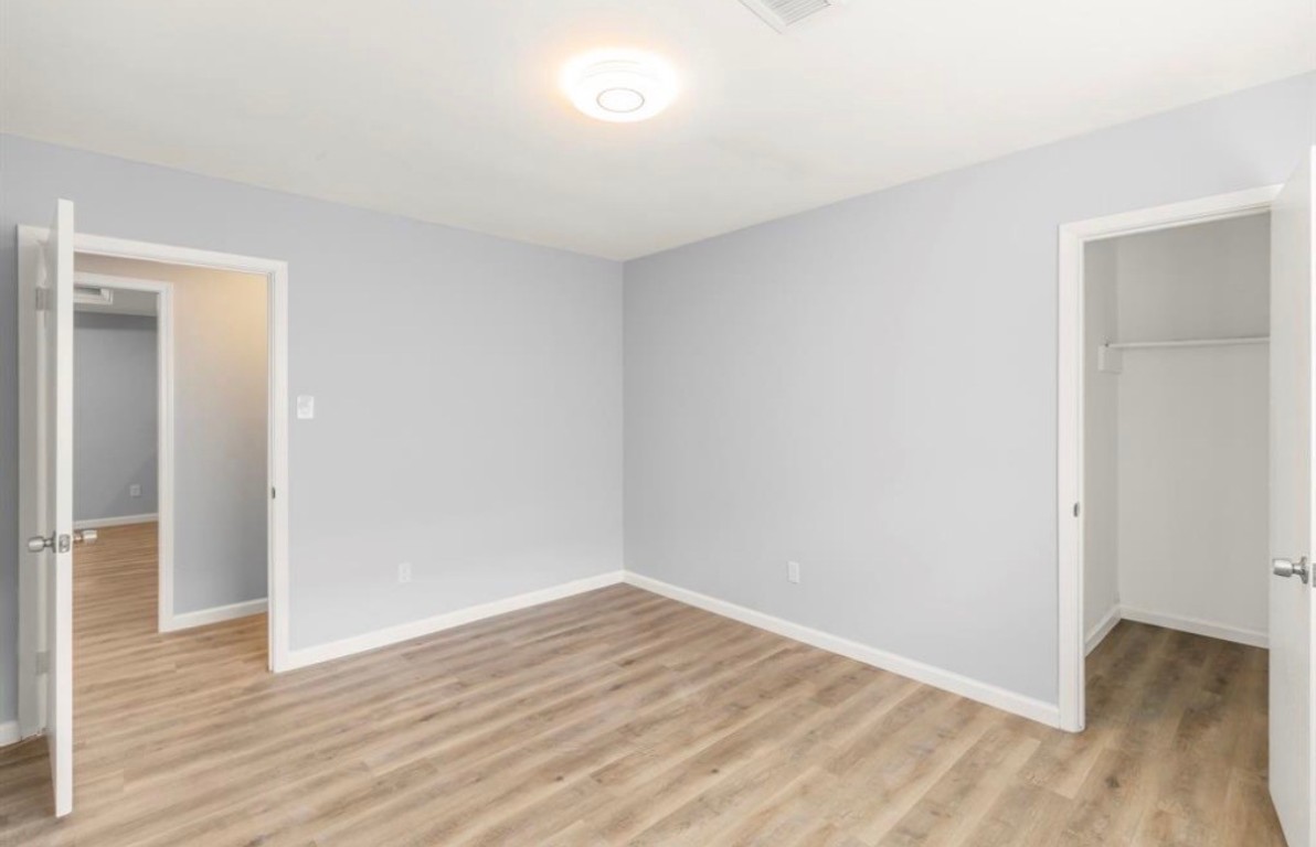 7515 Jason Street Houston, TX 77074 - Photo 21 of 24 a view of an empty room with wooden floor and a window