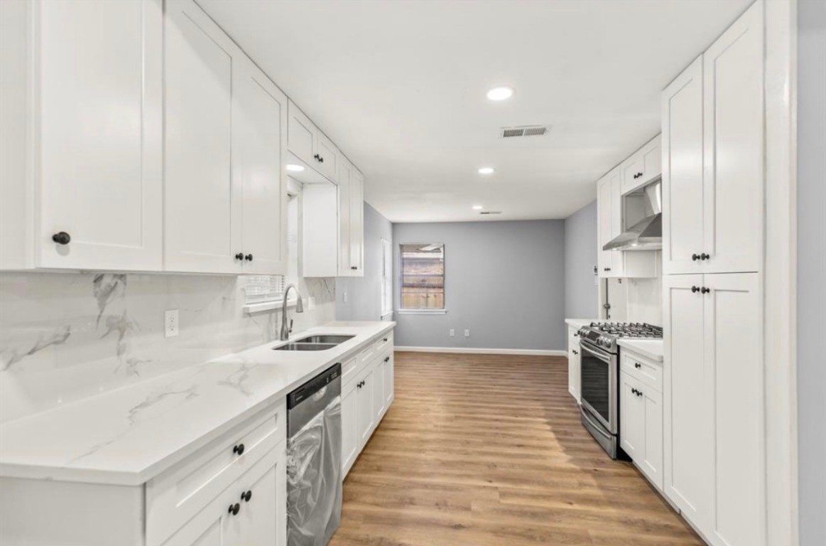7515 Jason Street Houston, TX 77074 - Photo 3 of 24 a kitchen with stainless steel appliances granite countertop a sink stove and refrigerator
