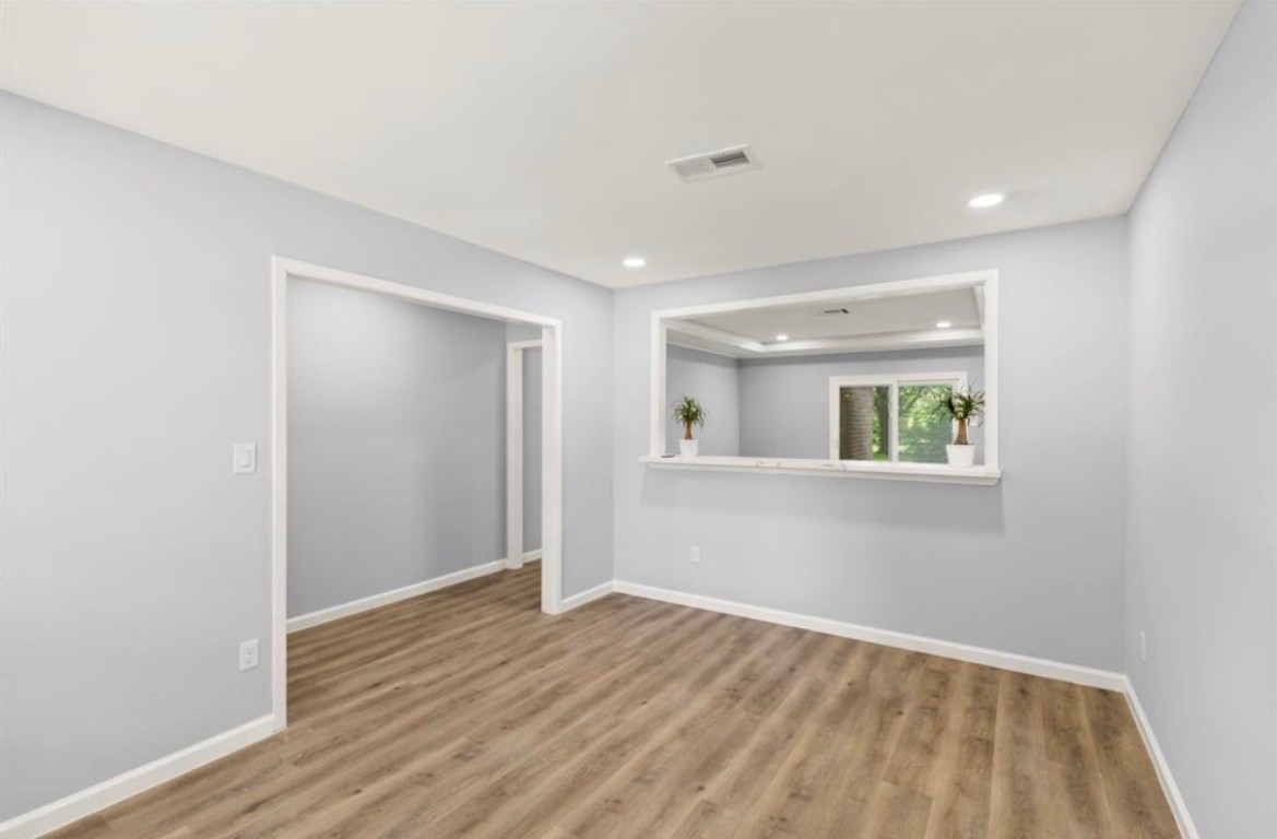 7515 Jason Street Houston, TX 77074 - Photo 10 of 24 a view of an empty room with wooden floor and a window