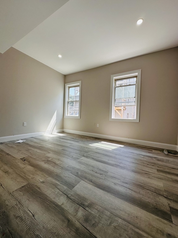 8 Wave Avenue, Unit 3 Boston, MA 02125 - Photo 2 of 5 a view of empty room with wooden floor