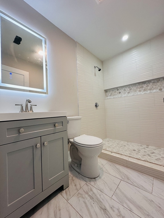8 Wave Avenue, Unit 3 Boston, MA 02125 - Photo 4 of 5 a bathroom with a toilet sink and mirror