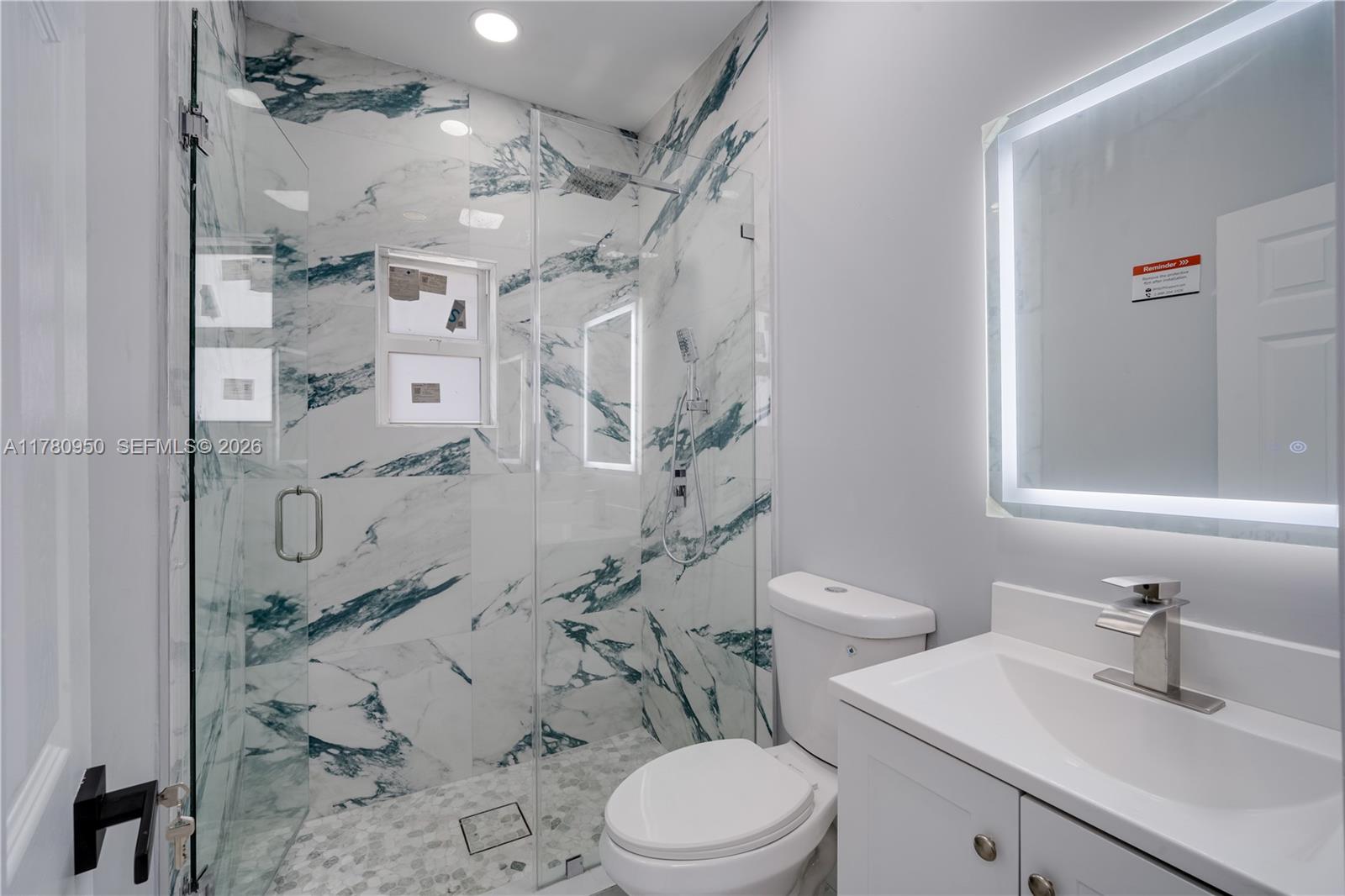 1114 Southwest 13th Court Miami, FL 33135 - Photo 18 of 43 a bathroom with a sink toilet vanity and shower