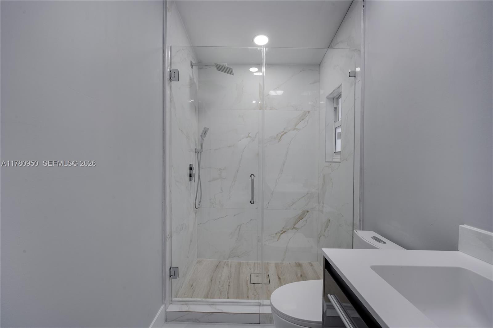 1114 Southwest 13th Court Miami, FL 33135 - Photo 19 of 43 a bathroom with a toilet a sink and shower
