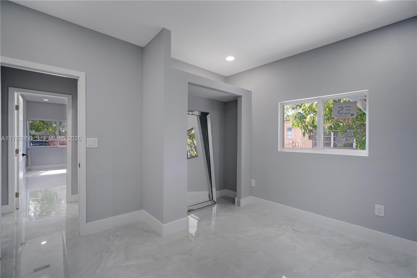 1114 Southwest 13th Court Miami, FL 33135 - Photo 24 of 43 an empty room with windows and closet