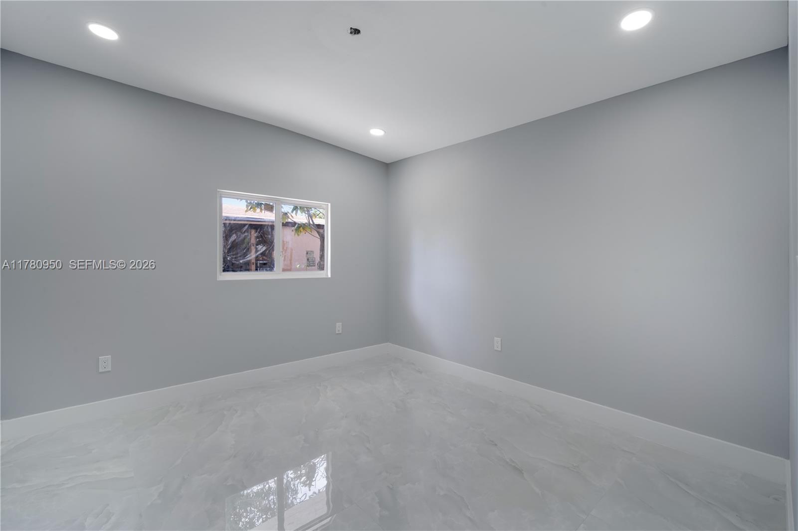 1114 Southwest 13th Court Miami, FL 33135 - Photo 25 of 43 an empty room with a window