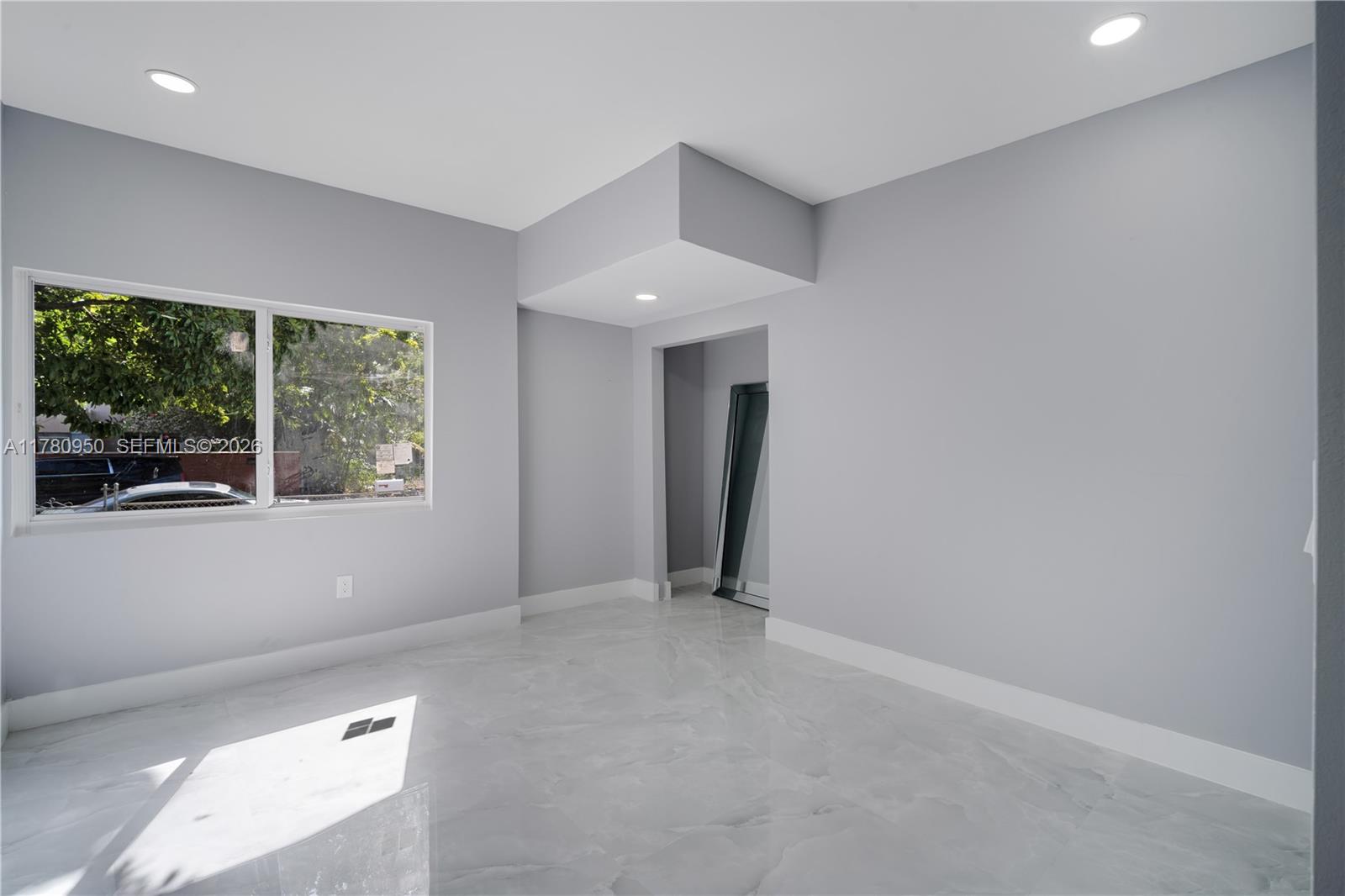 1114 Southwest 13th Court Miami, FL 33135 - Photo 26 of 43 a view of an empty room with a window