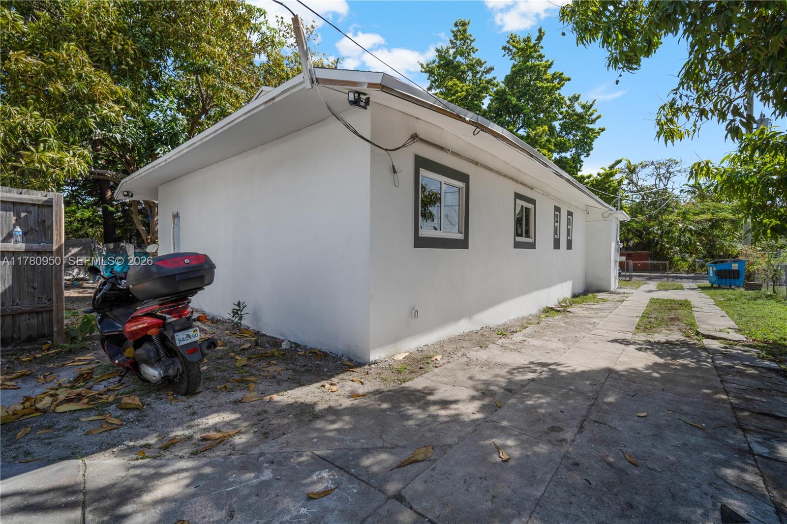 1114 Southwest 13th Court Miami, FL 33135 - Photo 27 of 43 a backyard of a house with fire pit and outdoor seating