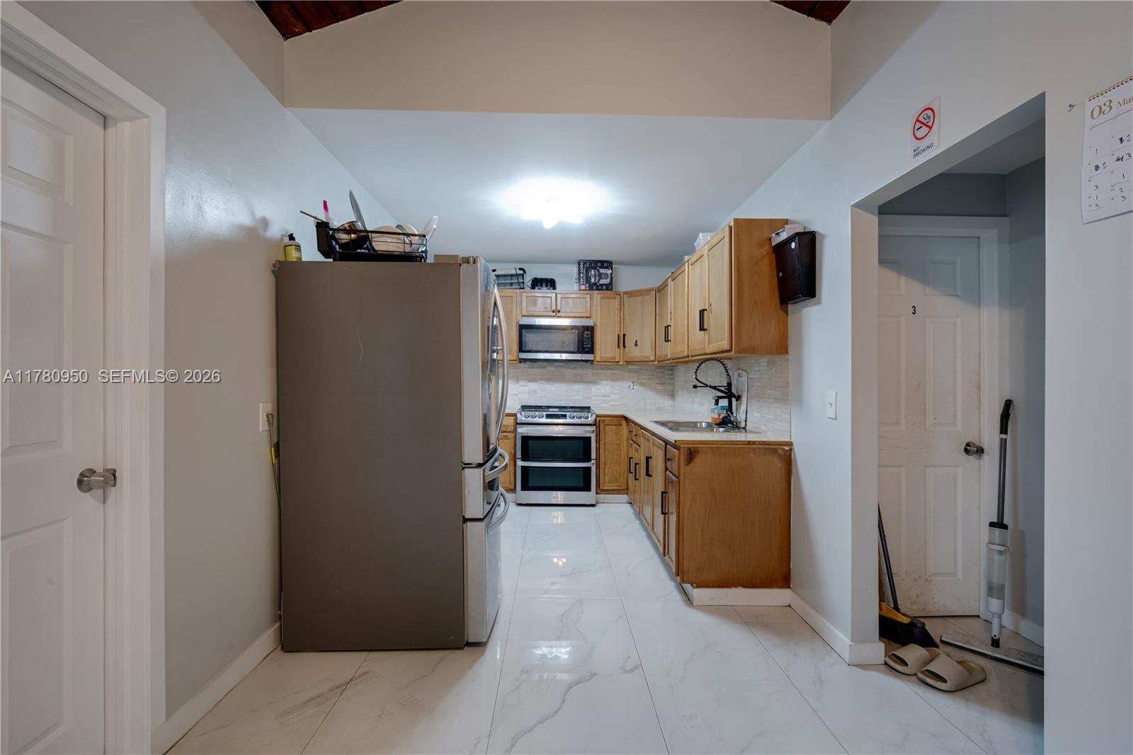 1114 Southwest 13th Court Miami, FL 33135 - Photo 33 of 43 a kitchen with stainless steel appliances granite countertop a refrigerator and a sink