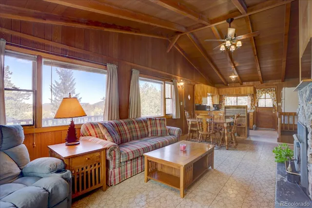 a living room with furniture a chandelier and a window