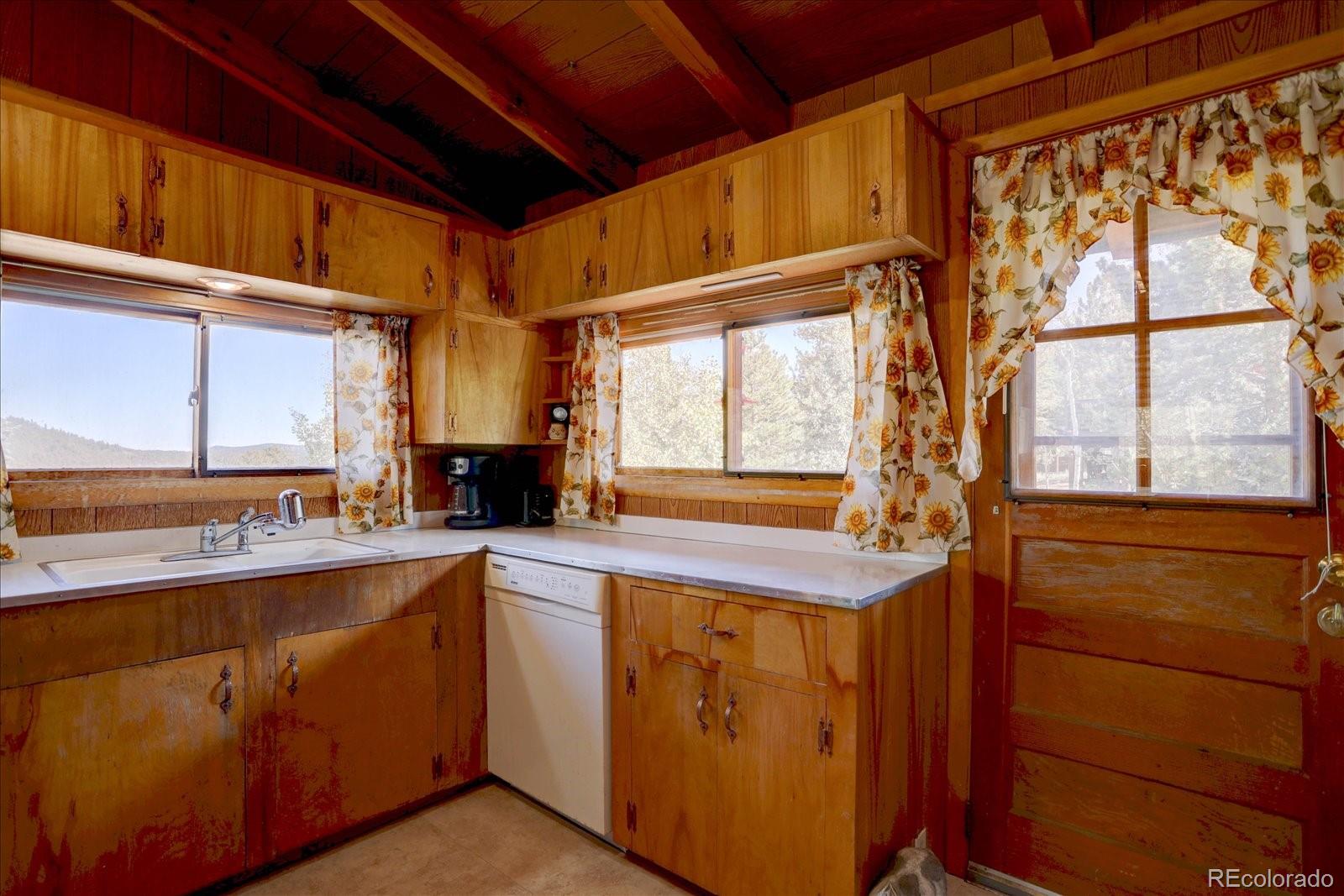 255 Saddlestring Road Bailey, CO 80421 - Photo 13 of 49 a kitchen with a sink and large window